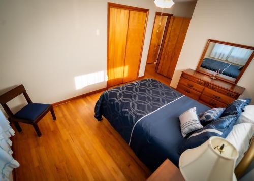 a bedroom with a bed and a chair in it at Amazing House Hot Tub Mins To Major Hospitals in Middle Valley