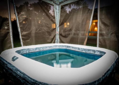 a jacuzzi tub in the middle of a room at Amazing House Hot Tub Mins To Major Hospitals in Middle Valley