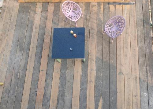 an overhead view of a table and chairs on a deck at 2BHK Cliff Side Villa in Mount Ābu