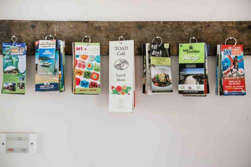 a bunch of signs hanging on a wall at The Pear Orchard Lodge in Richmond