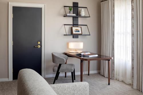 a room with a desk with a chair and a lamp at Fairmont Scottsdale Princess in Scottsdale