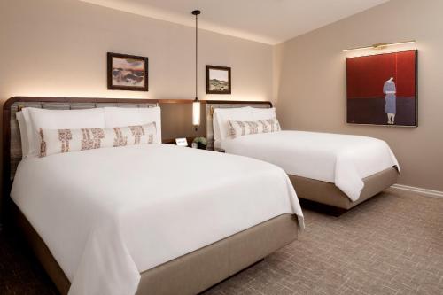 a hotel room with two beds and a tv at Fairmont Scottsdale Princess in Scottsdale