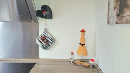 a kitchen with a figurine of a woman on the counter at Heimatliebe Neuried 20 Min zum Europa-Park in Neuried