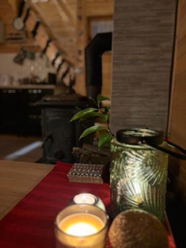 a candle and a vase on top of a table at Brvnaria in Slatina Varoš