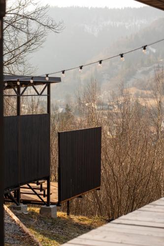 a stage with lights and a view of a mountain at Mirest - котеджі в горах із чаном-джакузі in Slavske