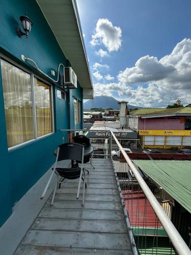 a table and chairs sitting on the porch of a building at Hotel Las Colinas in Fortuna