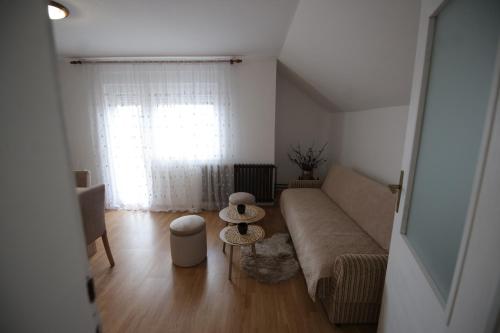 a living room with a couch and a window at Apartman La Perla in Vrbas