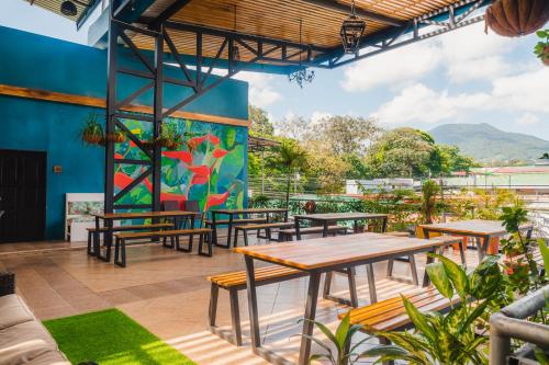 a group of tables and benches on a patio at Hotel Las Colinas in Fortuna