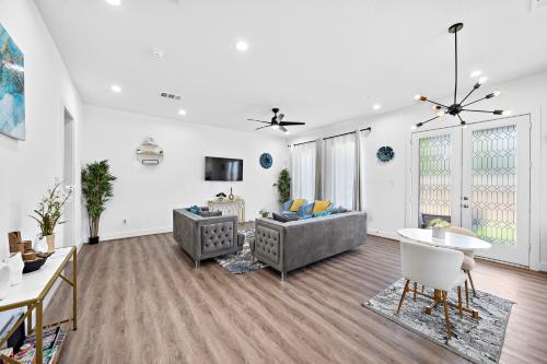 a living room with a couch and a table at Cozy Home Near MedCenter, Uptown, & Downtown in Houston