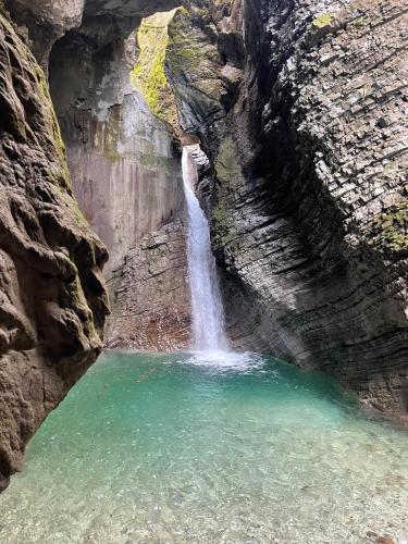 a waterfall in a canyon with a pool of water at Nadiza Hilltop Retreat in Breginj