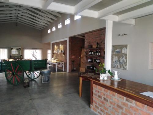 a room with a wagon in the middle of a room at Munsterland Guest Farm in Outjo