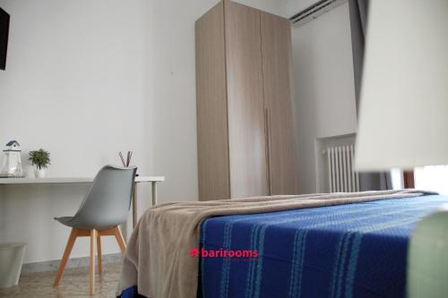 1 dormitorio con 1 cama con silla y mesa en BARI ROOMS Central Station, en Bari
