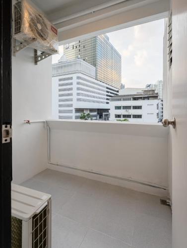 a room with a window with a view of a city at Silom Condominium in Bang Rak
