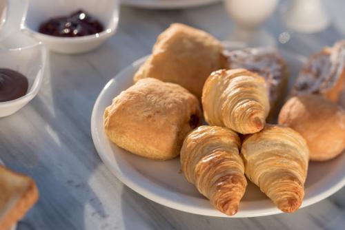 a plate of pastries and croissants on a table at Keti Hotel in Fira