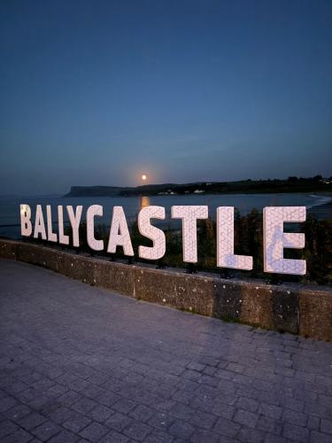a large sign that says ballascale on a wall at An Caislean incorporating Corratavey in Ballycastle