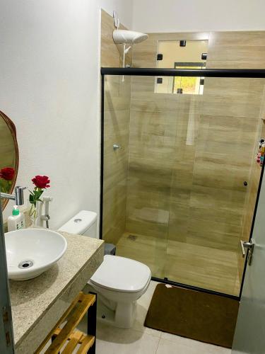a bathroom with a shower with a toilet and a sink at Suíte Lençóis in Lençóis