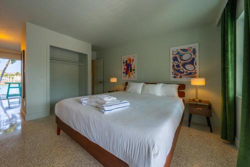 a bedroom with a large bed with towels on it at Tropical Breeze in Clearwater Beach