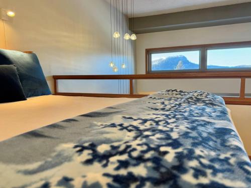 a bedroom with a large bed with a window at Lutsen Mtn Ski in Ski out Pool Hot Tub Fire Pit in Lutsen