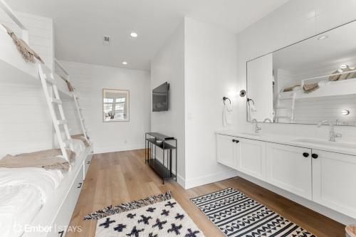 a white bathroom with a sink and a mirror at Deja Blue at Desert Color by Ember Stays in St. George