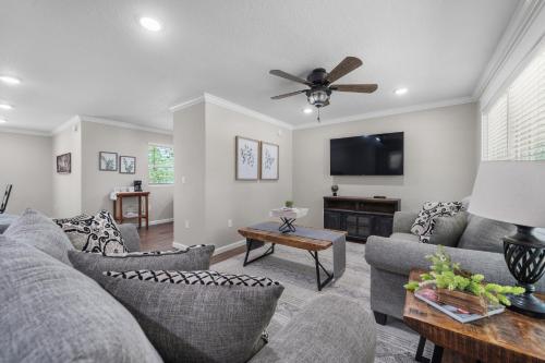 a living room with couches and a flat screen tv at Nordin's LakeHouse, Lakefront Hideaway on Delaware Bay Sleeps 10 in Dardanelle