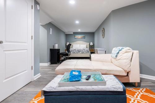 a living room with a couch and a table at Semi Private cozy studio near downtown. in Montclair