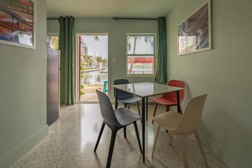 a dining room with a glass table and chairs at Tropical Breeze in Clearwater Beach