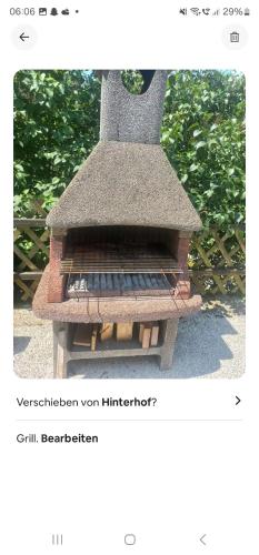 an outdoor grill is shown with a picture at Ferienwohnung Katharina in Steinbach am Attersee