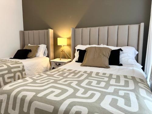 a bedroom with two beds with a large headboard at 3Bedrooms-5 min Downtown-Wifi-Pool-Jacuzzi-Parking in San Miguel de Allende