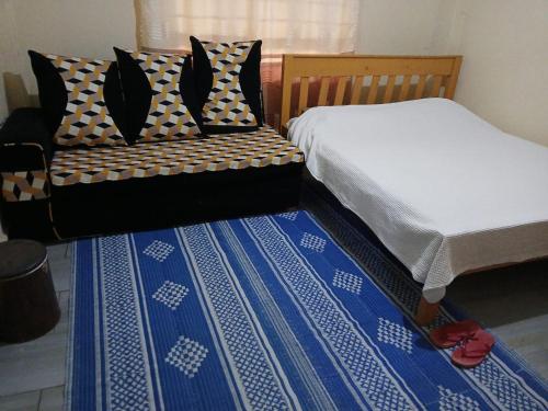 two beds sitting next to each other in a room at Airbnb in Mwea town in Thiba