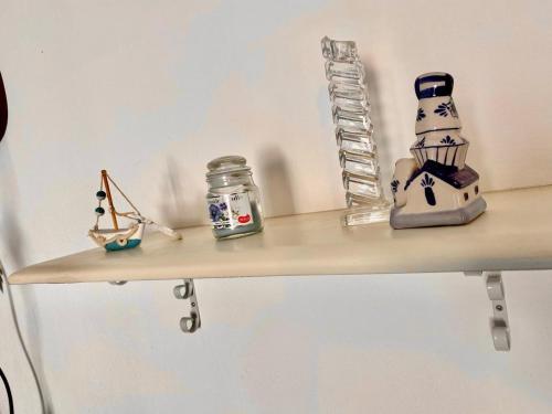a shelf with a blender and other items on it at Appartamento Valencia 50 meters from the shore in Torre Ovo
