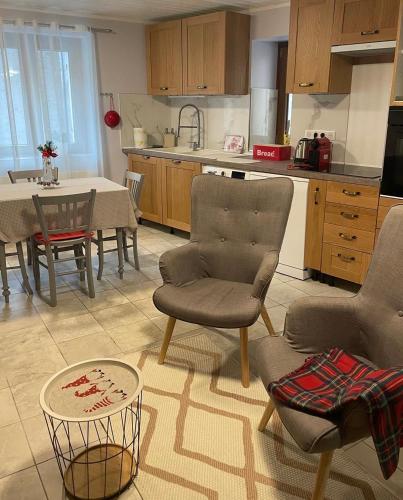 une cuisine avec une table et des chaises ainsi qu'une salle à manger dans l'établissement Bienvenue, à Saint-Dalmas-le-Selvage