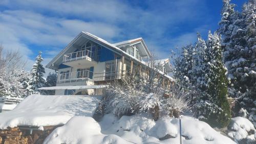 a house in the snow with snow covered trees at Ferienhaus Kirsch in Missen-Wilhams