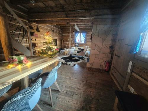 a living room with a christmas tree and a table and chairs at Drevenička Zázrivá Terchová in Zázrivá