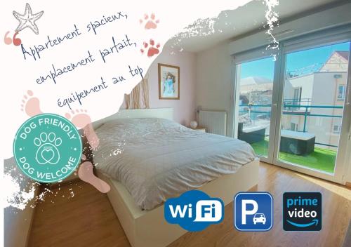 a bedroom with a bed and a large window at Fl’Heurt de Mer appartement au pied de la plage, vue mer in Le Portel