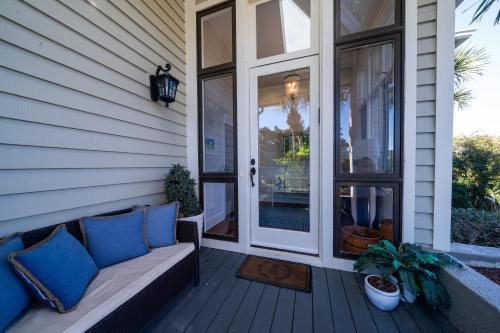 a porch with a couch and a glass door at 2251 Catesby's Bluff in Seabrook Island