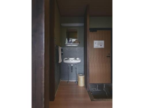 a bathroom with a sink and a mirror at Ryokan Akebono - Vacation STAY 91891v in Saga