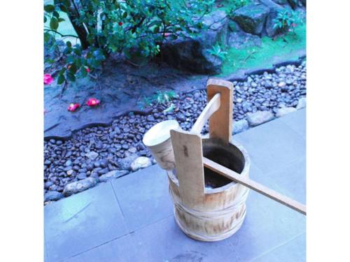a wooden mortar and pestle sitting on a sidewalk at Ryokan Akebono - Vacation STAY 91900v in Saga