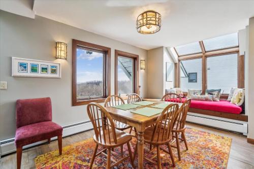 a dining room with a table and chairs and a couch at Sunrise Timberline K8 in Killington