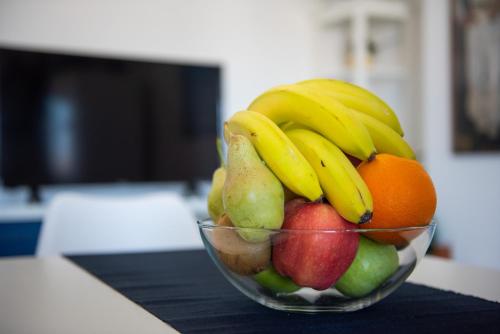 a bowl of fruit with bananas apples and pears at Serfanto house - Serifos in Livadion