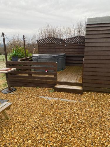 a wooden deck with a hot tub on it at Crabmill glamping bewdley in Bewdley