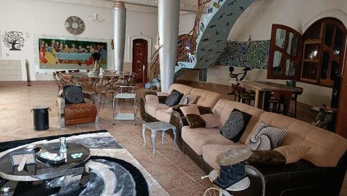 a living room with a couch and a table at Villa Gaudi (Gaoudi) in Akassato