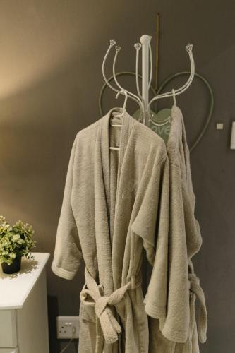 a towel hanging on a rack in a bathroom at Meraki Country Manor in Lanseria