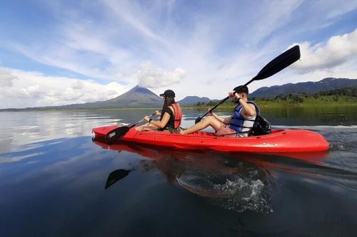 two people in a red kayak on a lake at Anchia - Hostel in Alajuela City