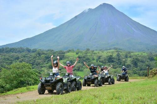 a group of people riding atvs down a mountain at Anchia - Hostel in Alajuela City