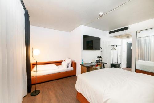 a bedroom with a bed and a couch at The Barthels Boutique Hotel in Würzburg
