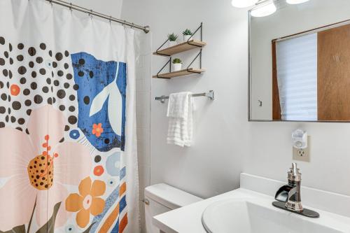 a bathroom with a sink and a shower curtain at Private Deck and Fire Pit Secluded Cabin in Murphy in Salem