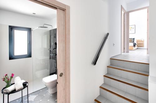 a bathroom with a shower and a toilet and a staircase at Casa Z Conil De La Frontera in Conil de la Frontera
