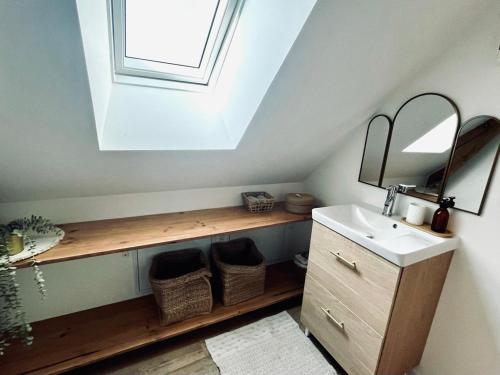 a bathroom with a sink and a mirror and a window at La Grange aux Souvenirs - Piscine chauffée ,Jacuzzi et Terrain de pétanque in Grèzes