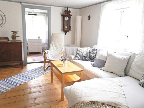 a living room with a white couch and a table at 6 person holiday home in HALLABRO-By Traum in Hallabro