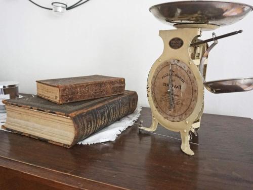 two old books and a clock on a table at 6 person holiday home in HALLABRO-By Traum in Hallabro